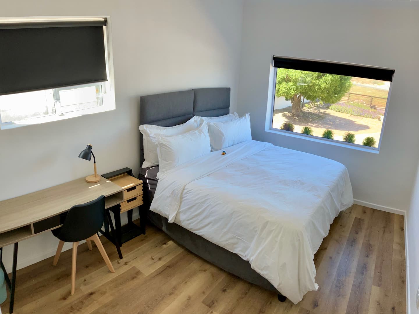 Second bedroom arranged as a king bed with white bedding