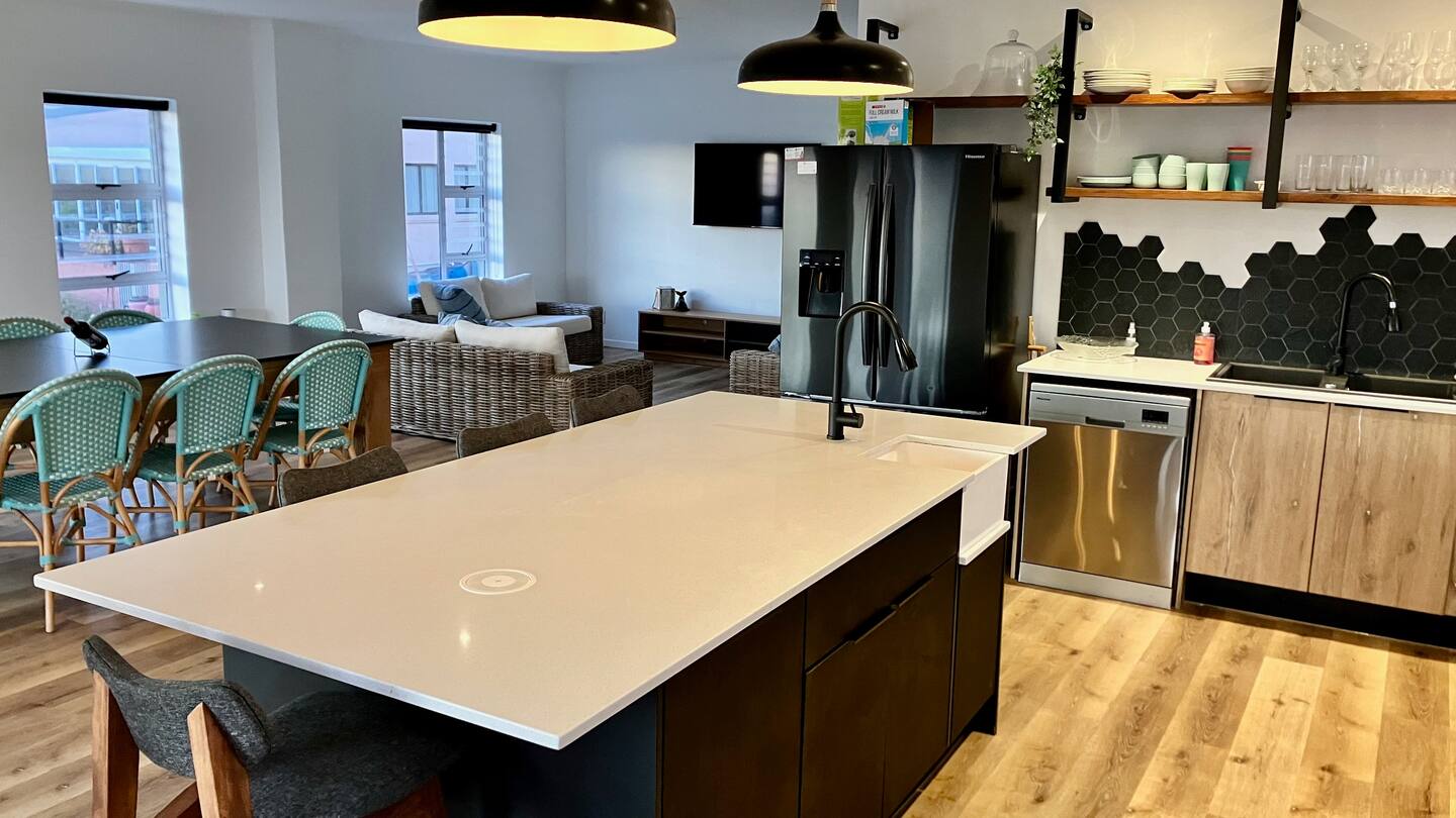 Kitchen island, dining table and lounge in one open space